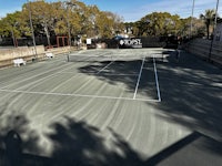 a tennis court with shadows on it