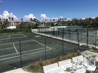 a tennis court with chairs and a net