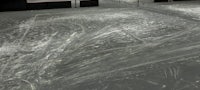 a skateboarder is riding a skateboard on a concrete floor