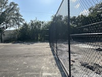 a tennis court with a chain link fence