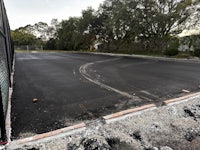 an aerial view of a road that is being paved