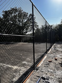 a tennis court with a chain link fence